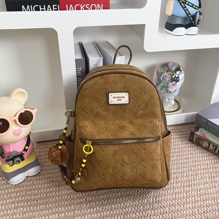 2025秋冬新款磨砂皮质卡通压印大容量双肩包时尚早八上课出游背包