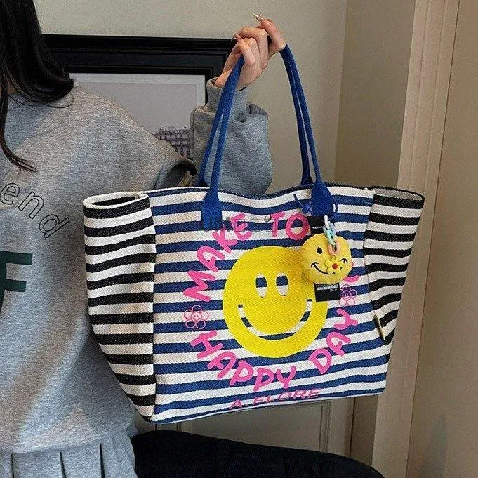 新款纹手提托特包女笑脸购物通勤包单肩包健身旅行包妈咪包潮百塔
