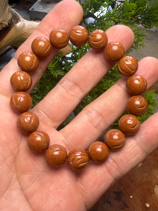 手工打磨小龙纹桃核光珠