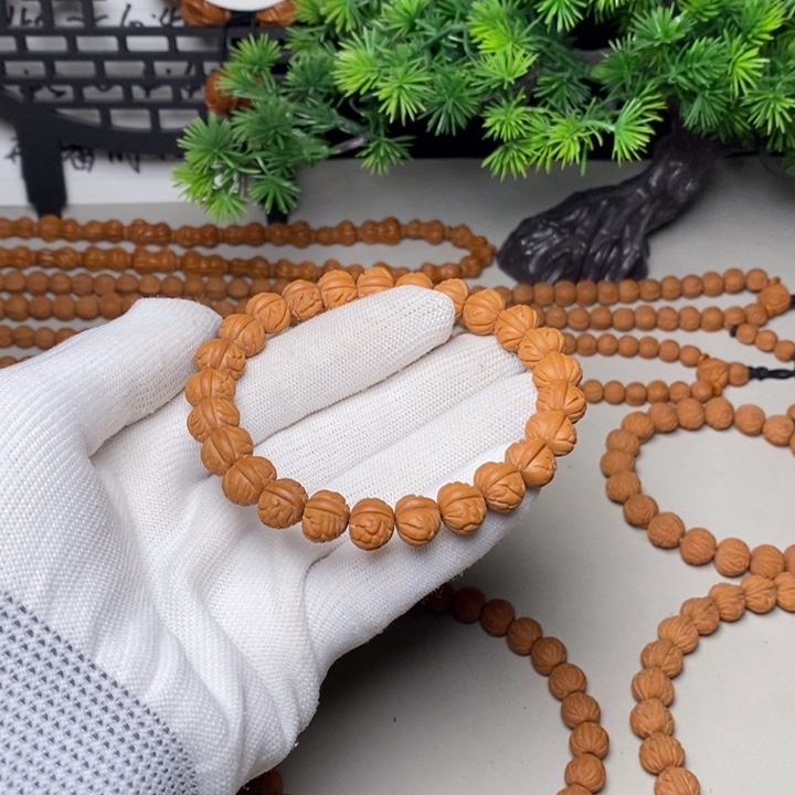 桃核手串凤羽聚宝盆