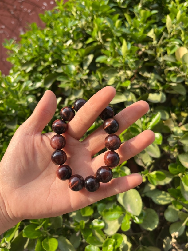 泗水砭石文化馆红麒麟眼卡14手把件