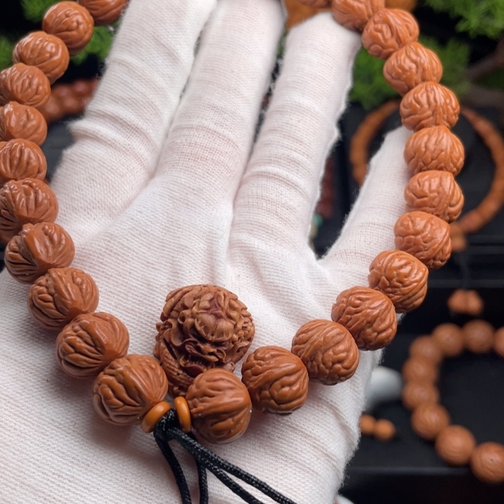 秃***儿桃核吊坠精品手持