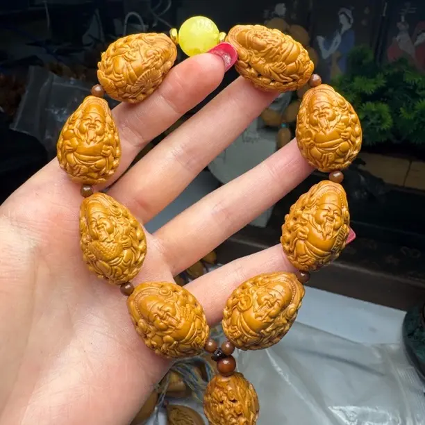 318文玩-橄榄核手串镂空财迷